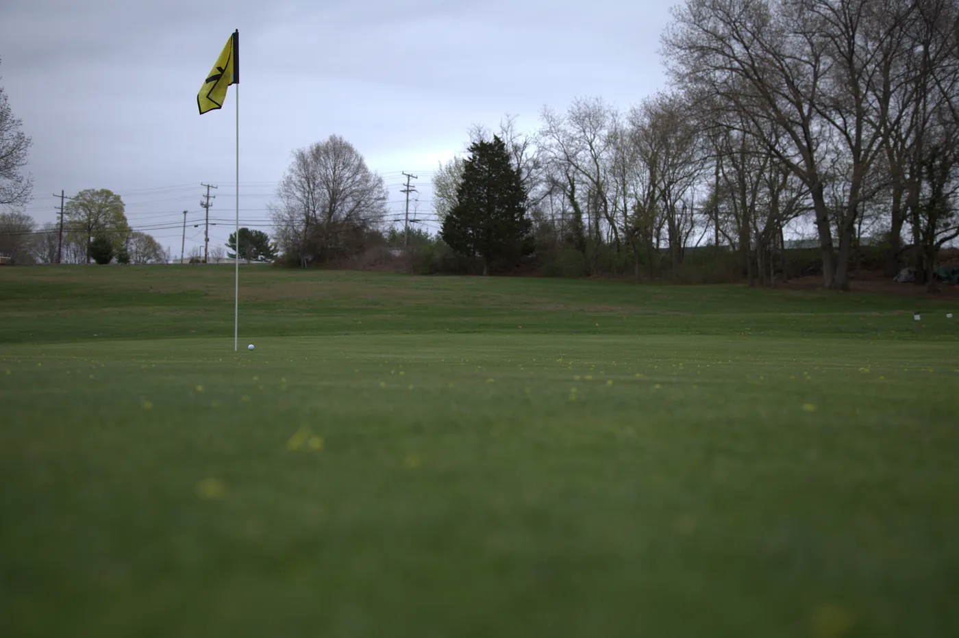 Flagstick and putting green at Silver Spring Golf Club in Riverside Rhode Island